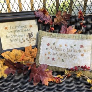Photo of finished Autumn Smalls set by Falling Star Primitives, displayed on wicker bench with Autumn leaves